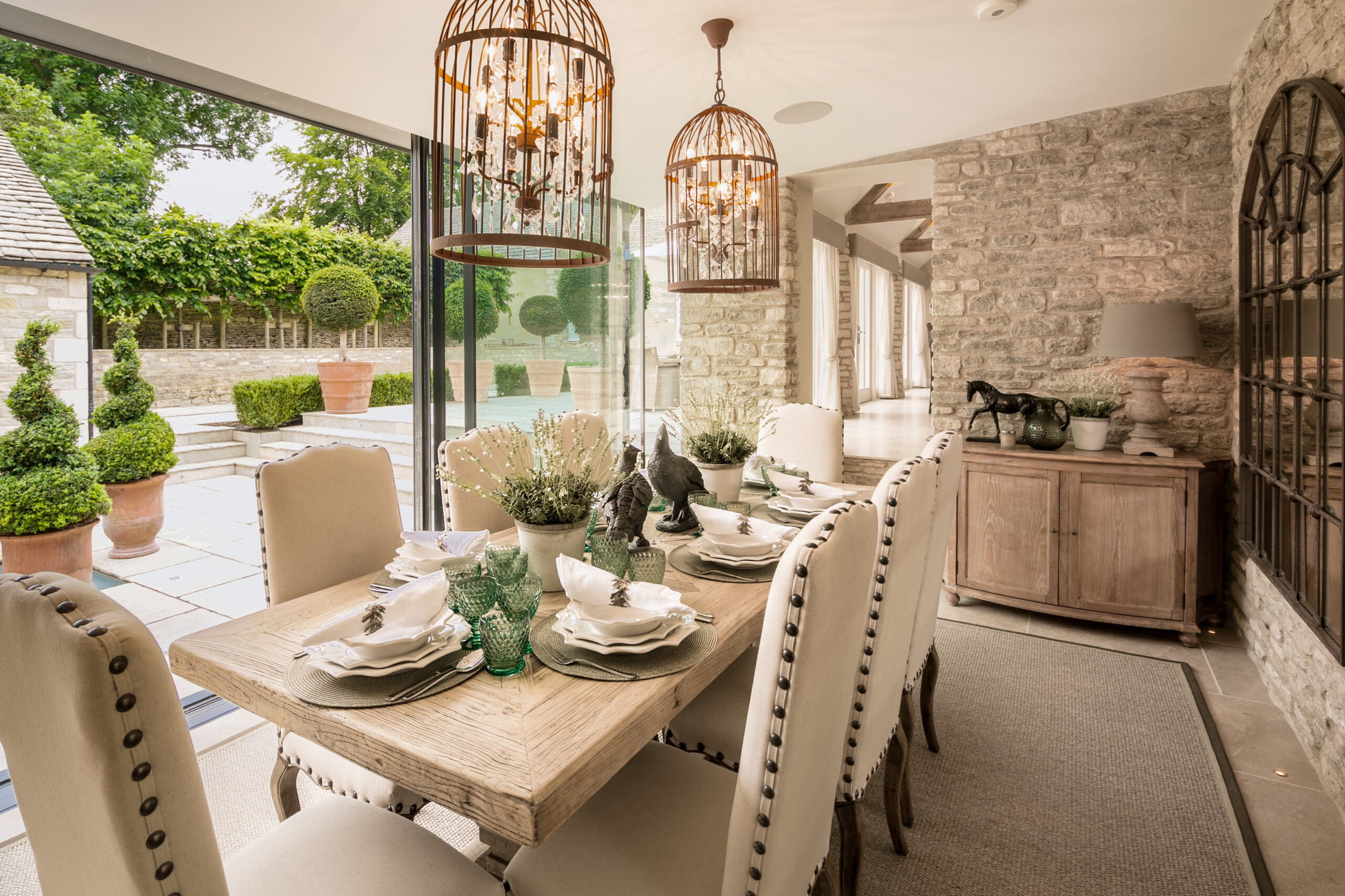 Luxury home featuring dining table and white chairs, outdoor setting